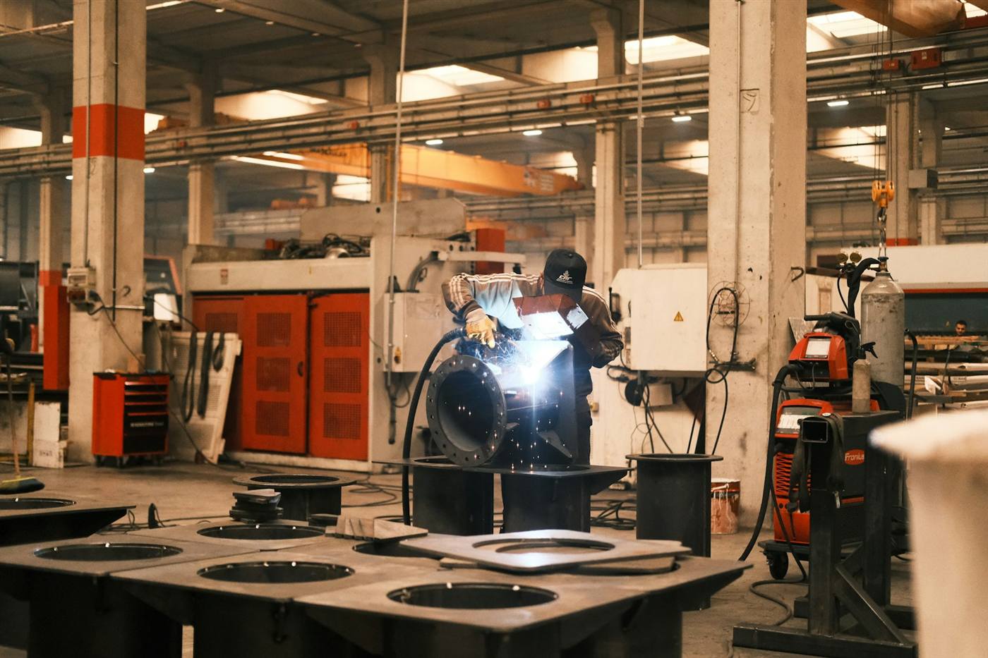 A welder joining steel in an industrial workshop
